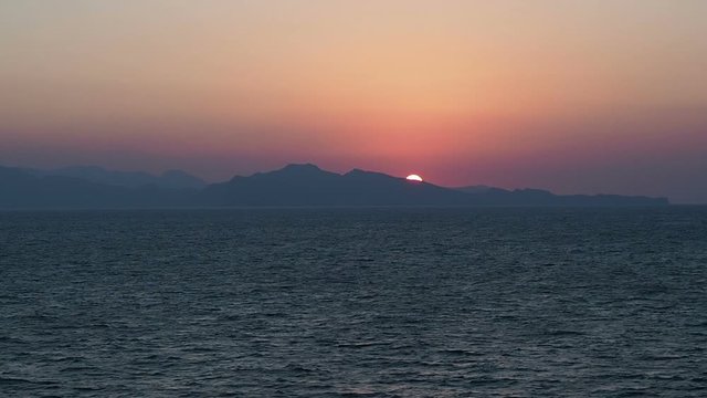 Magical sunset on the background of sea waves. View from cruise ship on the open sea