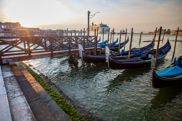 Fototapeta na wymiar Gondolas of Venice Italy in the morning against the backdrop of sunrise