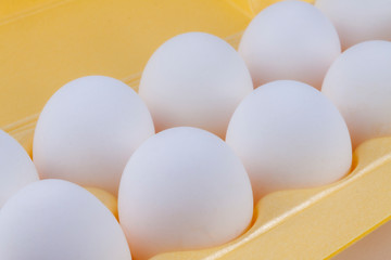 White chicken eggs lie in the package.