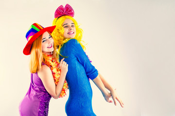 Attractive playful young women ready for carnival parties. Lifestyle and the concept of friendship: a group of two girl friends. Copy space