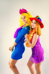 Attractive playful young women ready for carnival parties. Lifestyle and the concept of friendship: a group of two girl friends.