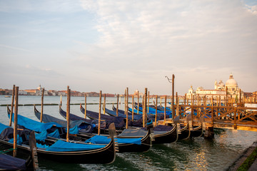 Fototapeta na wymiar Gondolas of Venice Italy in the morning against the backdrop of sunrise