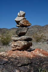 Rocks are piled in a stack known as a ciarn to mark a hikers passage along a trail.