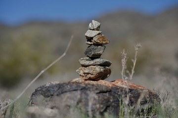 Rocks are piled in a stack known as a ciarn to mark a hikers passage along a trail.