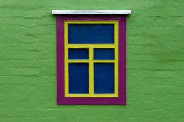 Beautifully decorated old window on a green wall. Unusual decoration. Horizontal orientation