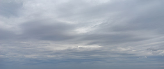 Dark blue sky with light clouds