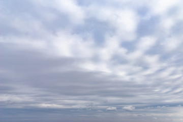 Dark blue sky with light clouds