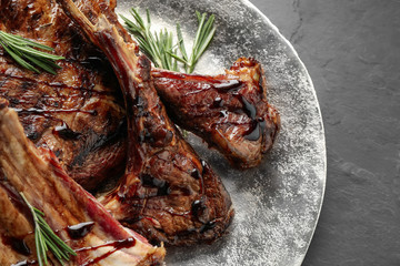 Delicious grilled ribs on black table, closeup
