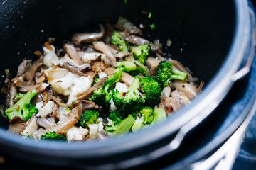photo of some vegetables cooking in a pot in a kitchen