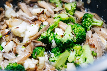 photo of some vegetables cooking in a pot in a kitchen