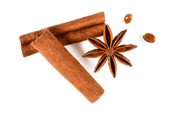 Cinnamon sticks and anise star spice with seeds. Close up macro isolated on white background with light shadow. Top view, flat lay,