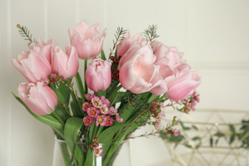 Beautiful bouquet with spring pink tulips on light background