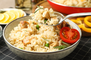 Delicious chicken risotto with tomato on table, closeup