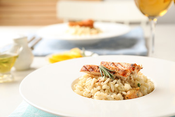 Delicious chicken risotto served on table, closeup