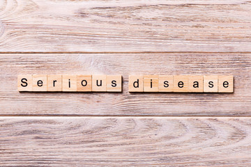 serious disease word written on wood block. serious disease text on wooden table for your desing, coronavirus concept top view
