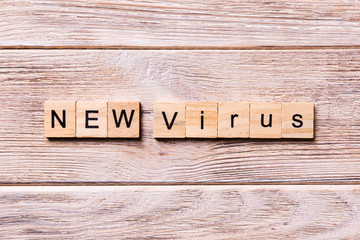 new virus word written on wood block. new virus text on wooden table for your desing, coronavirus concept top view