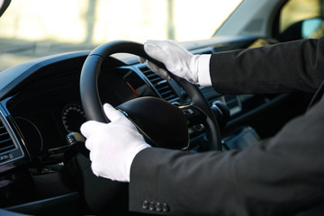 Professional driver in luxury car, closeup. Chauffeur service