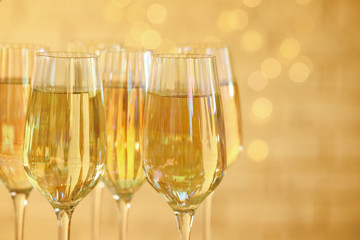 Glasses of champagne against blurred lights, closeup