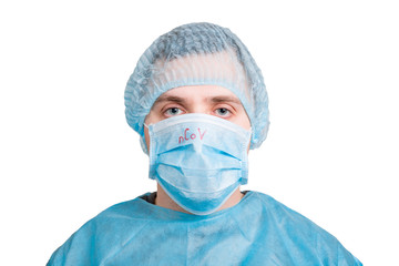 Portrait of young man wearing medical uniform and protective mask with nCoV word isolated on white background. Coronavirus and health care concept