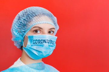Portrait of a woman wearing medical uniform and mask with coronavirus word at red background. Coronavirus concept. Respiratory protection concept with copy space