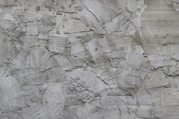 irregular surface of cement with spatula texture - messy gray wall background 