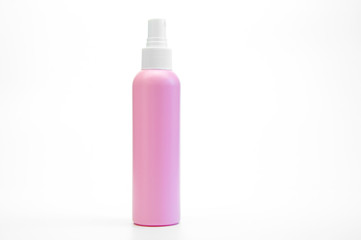 Pink bottle with white spray or dispenser. On white background. Hairdresser and beauty salon accessories