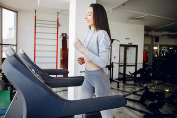 Beautiful girl in the gym. A woman training in a sports clothes