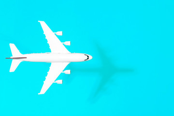Travel minimal background. Model airplane in flight on an empty colored background. Copy space
