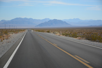 Fototapeta na wymiar Death Valley Junction, California - November 11, 2019: Road on the way to Death Valley National Park in California, USA