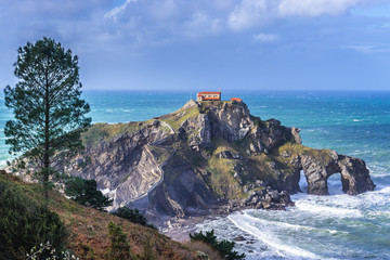 Fototapeta na wymiar Gaztelugatxe isle with famous San Juan hermitage located on Bay of Biscay of the northeast Atlantic Ocean in Spain