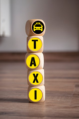 Cubes and dice with word taxi and taxi icon