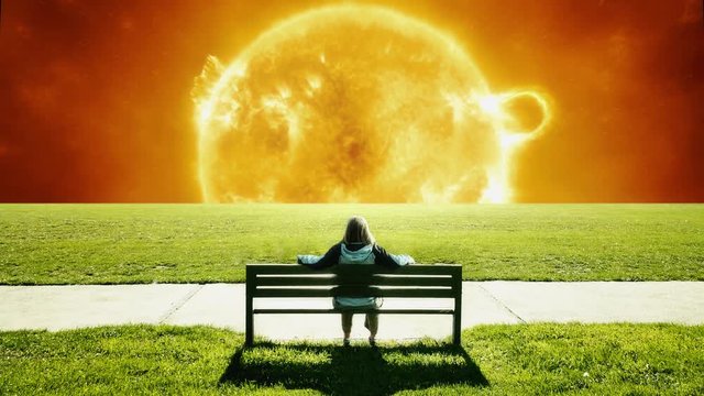 Woman sitting on the park bench looking at the giant sun. Science-fiction, fantasy, apocalyptic scene. Based on NASA photograph.