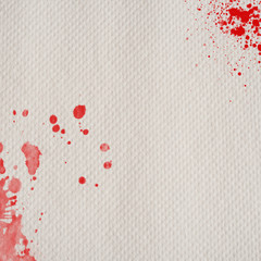 white paper towel with red splatters