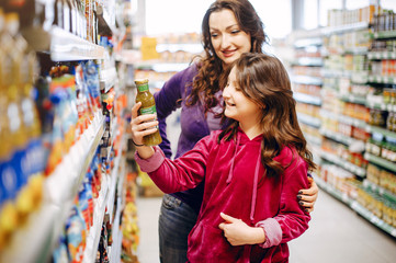 Mother with a daughter. Family in a supermarket