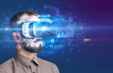 Businessman looking through Virtual Reality glasses with SERVERS inscription, innovative technology concept