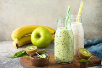 Healthy dieting and nutrition. Vegetarian concept. Blended Green detox vegetable smoothies with organic ingredients on a stone concrete tabletop. Copy space.