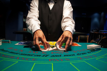 Dealer shuffles the cards in casino - obrazy, fototapety, plakaty