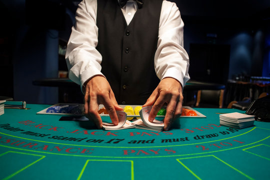 Dealer shuffles the cards in casino