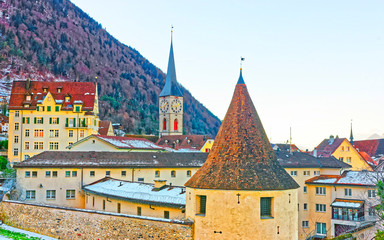 Naklejka premium Tower and Church of St Martin in Chur in morning. Chur is the capital of canton Graubunden in Switzerland. It lies in the Alpine Grisonian Rhine valley. The city is the oldest town of Switzerland