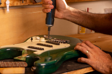 luthier working on repairing a guitar