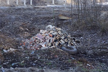 a pile of construction debris on the street with all the grass and ground