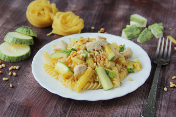 The concept of Italian cuisine. Pasta with zucchini and cheese on an old wooden background. Copy space