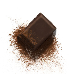 Dark chocolate piece on cocoa powder isolated on white background