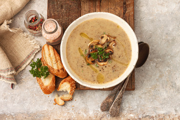 Bowl with mushroom soup on table