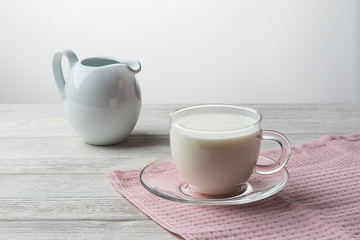Pouring homemade kefir, yogurt with probiotics. Probiotic cold sour-milk drink. Fashionable food and drinks.