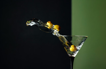 Martini with green olives splash.