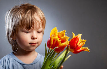 cheerful kid with a bouquet of tulips