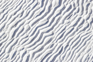 White texture of Pamukkale calcium travertine in Turkey, pattern of the waves close-up