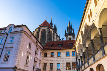 Beautiful view of the old streets of Prague, Czech Republic. In the distance you can see the spires of the Church of Mother of God before Tyn. On both sides of the street are buildings with beautiful 