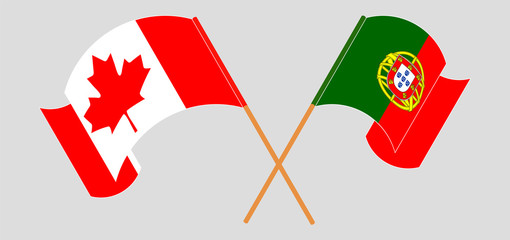 Crossed and waving flags of Portugal and Canada